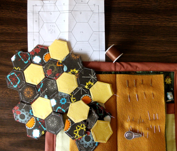 needle book with in-progress hexagon mug rug top